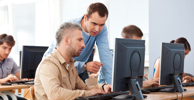 Individuals engrossed in computer training, complementing the blog featuring employment tips from Vanessa Q., a Reentry Program Supervisor, specializing in job readiness, educational programming, and vocational training enrollment assistance.