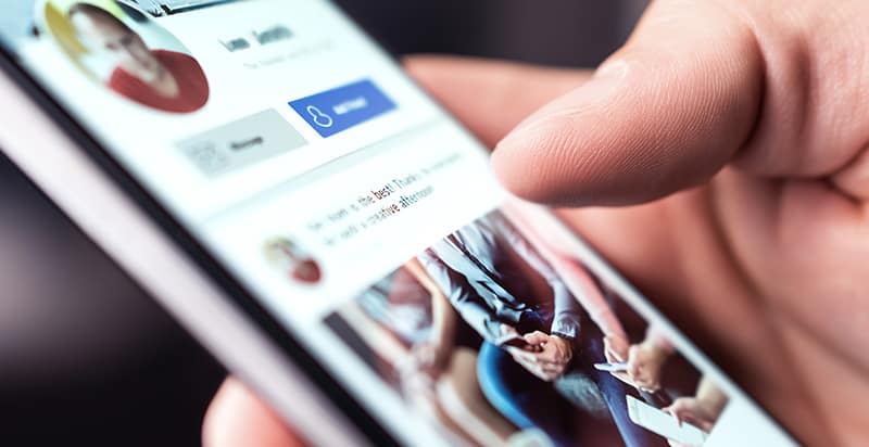 A close-up of a phone on a social media page, emphasizing the blog's focus on cleaning up your digital footprint and the importance of a pristine online presence.